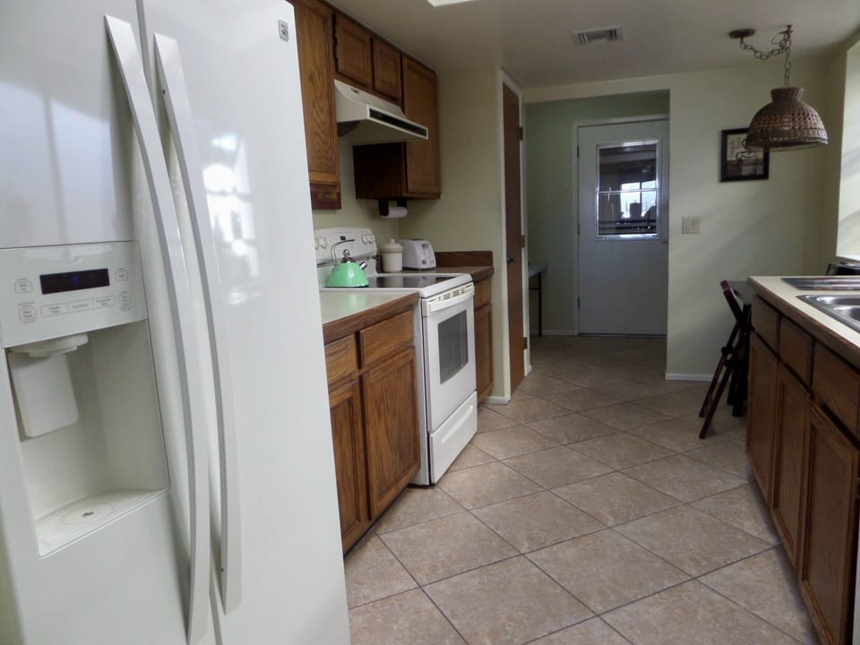 Kitchen, desk/table,  laundry room with washer/dryer 