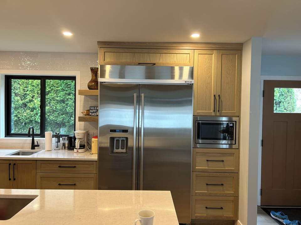 There is a large fridge with freezer and an ice and water dispenser.