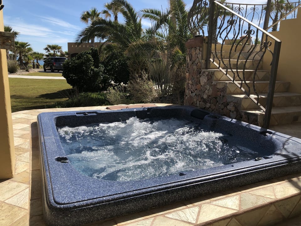 Enjoy the hot tub while looking to the beach and pools. 
