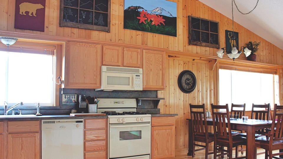 Full kitchen with dishwasher and dining table