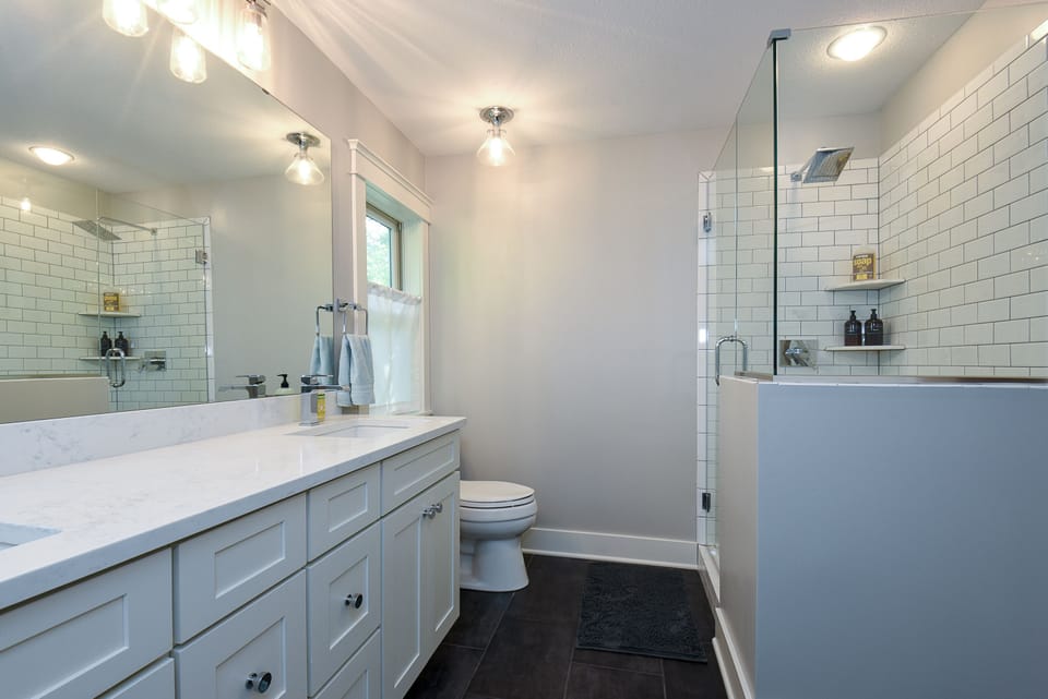 Master bath with soaking tub, walk-in shower and park views.
