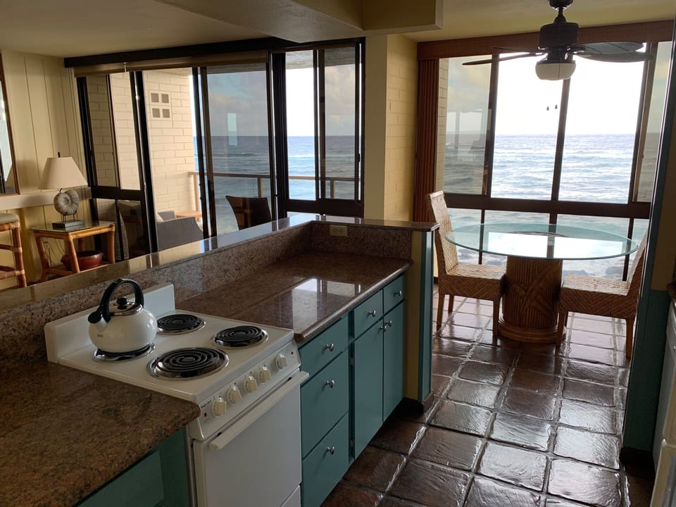 Galley kitchen with a view of the ocean.