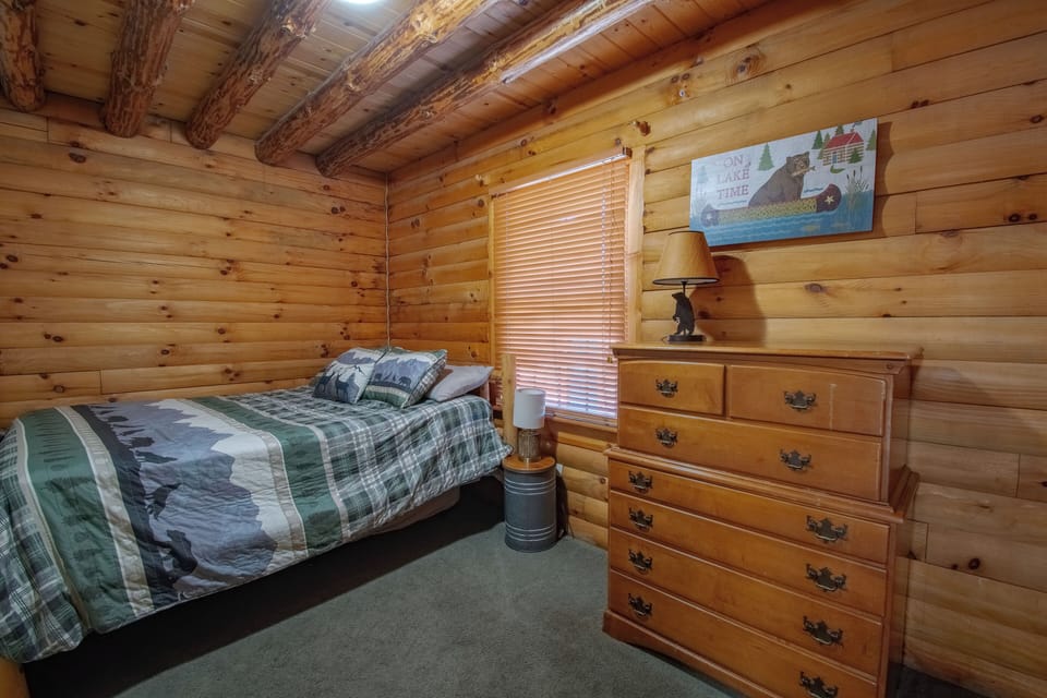 Main floor bedroom with queen bed and twin size trundle underneath