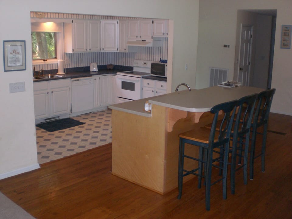 View from DR looking down into kitchen. Hall to upstairs and Bedrooms on right.