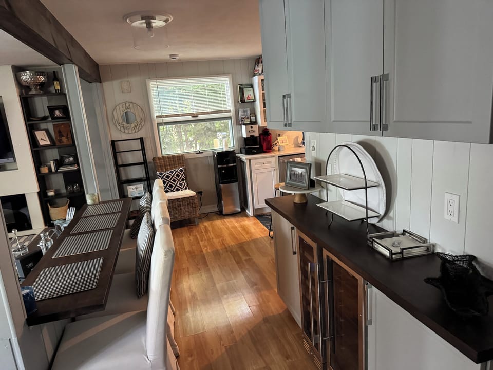 Breakfast bar, beverage fridge, wine fridge, cabinets,water cooler