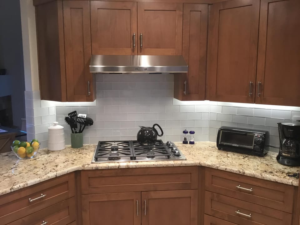 Dacor four burner, gas cooktop with lighted hood (exterior ventilation ).