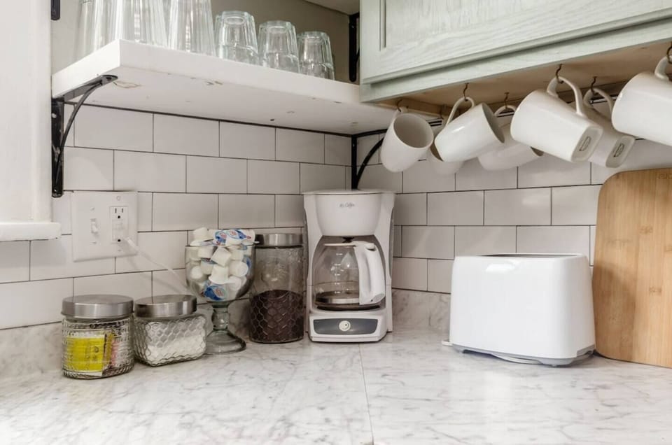 Mr Coffee pot with Folgers coffee, sugar, and creamer