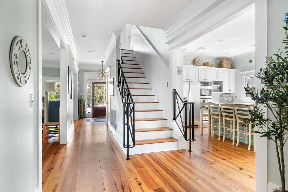 Main hall creates open transit to kitchen, great room, and upstairs.