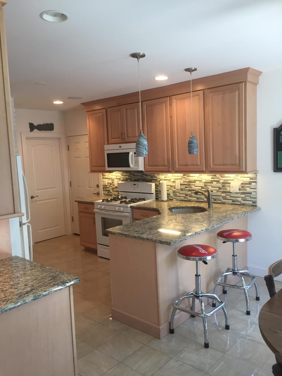 Partial photo of kitchen with breakfast bar and dining table for four plus NICE
