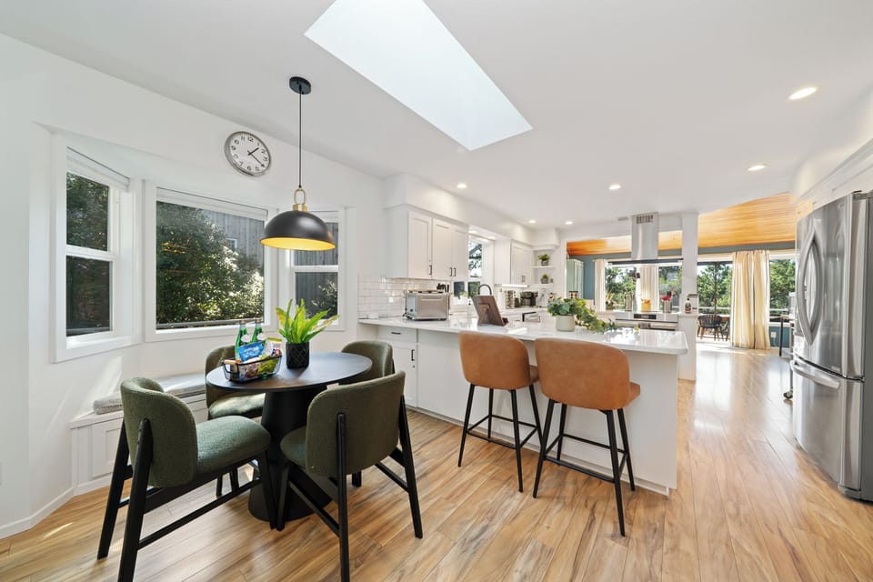Bright, modern kitchen with a breakfast nook, island seating, and skylight—perfect for gathering and easy mornings.