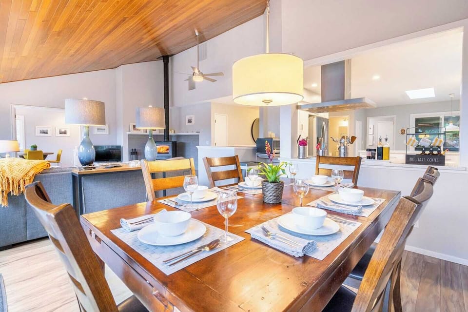 Share meals and memories in this sunlit dining room surrounded by forest views — the perfect setting for connection and conversation