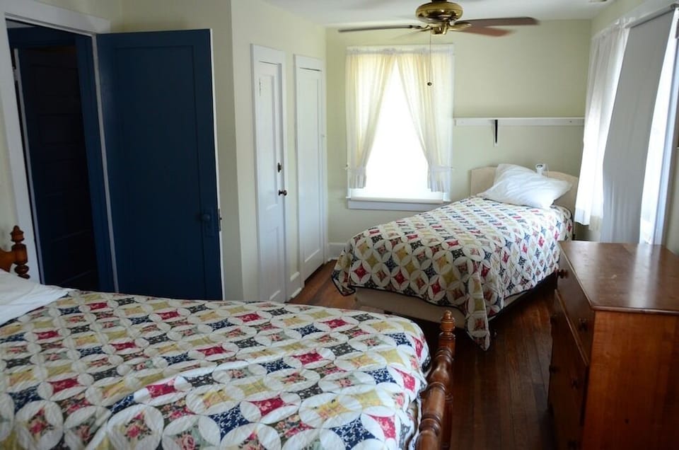 Front bedroom has three beds and a great ocean breeze.