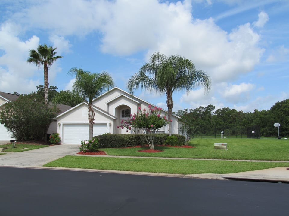 Front view showing lack of neighbors and open grass area next door.