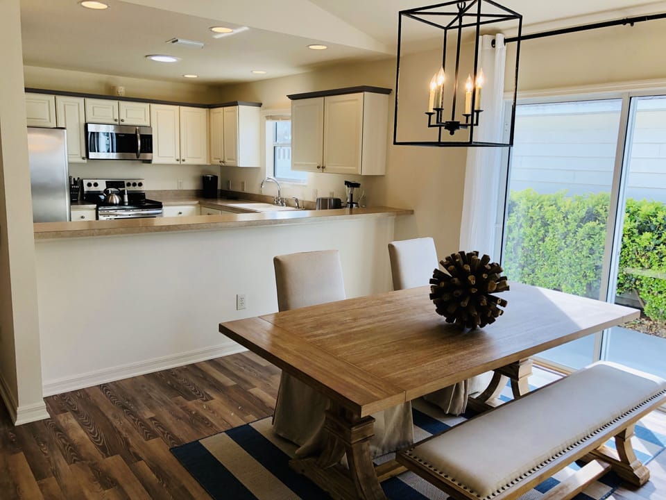 Dining area with kitchen in background