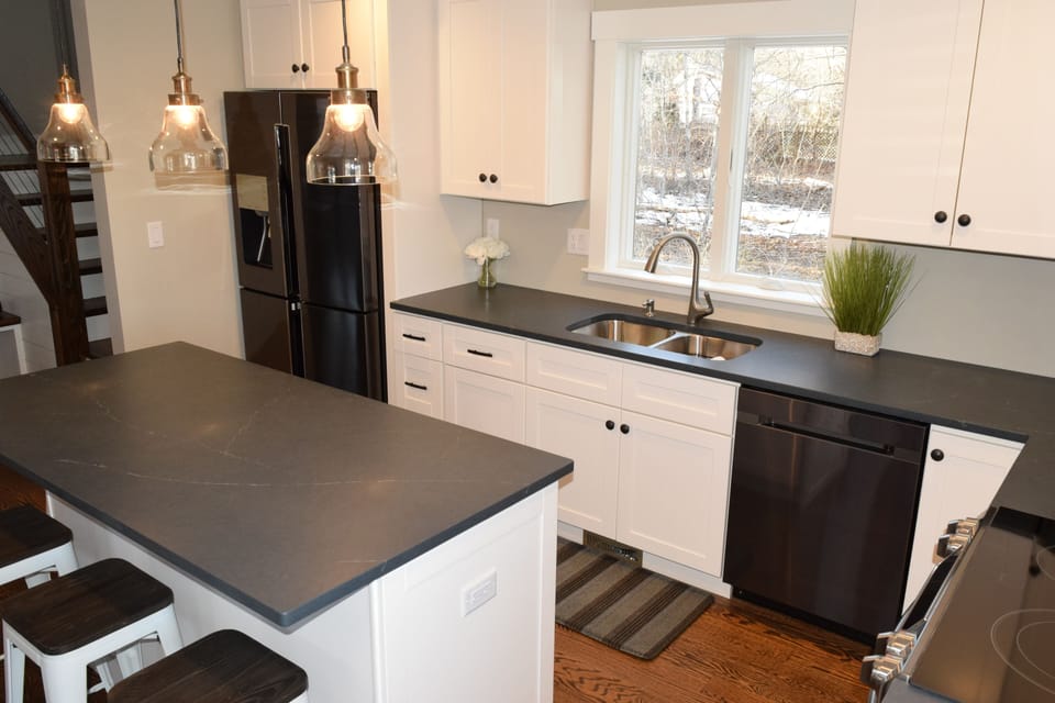Gormet kitchen with black stainless appliances