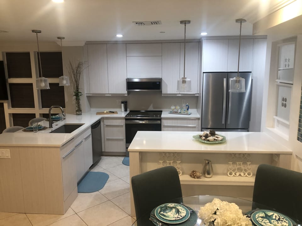 Remodeled kitchen open and stocked with plenty of dishes and cooking supplies.
