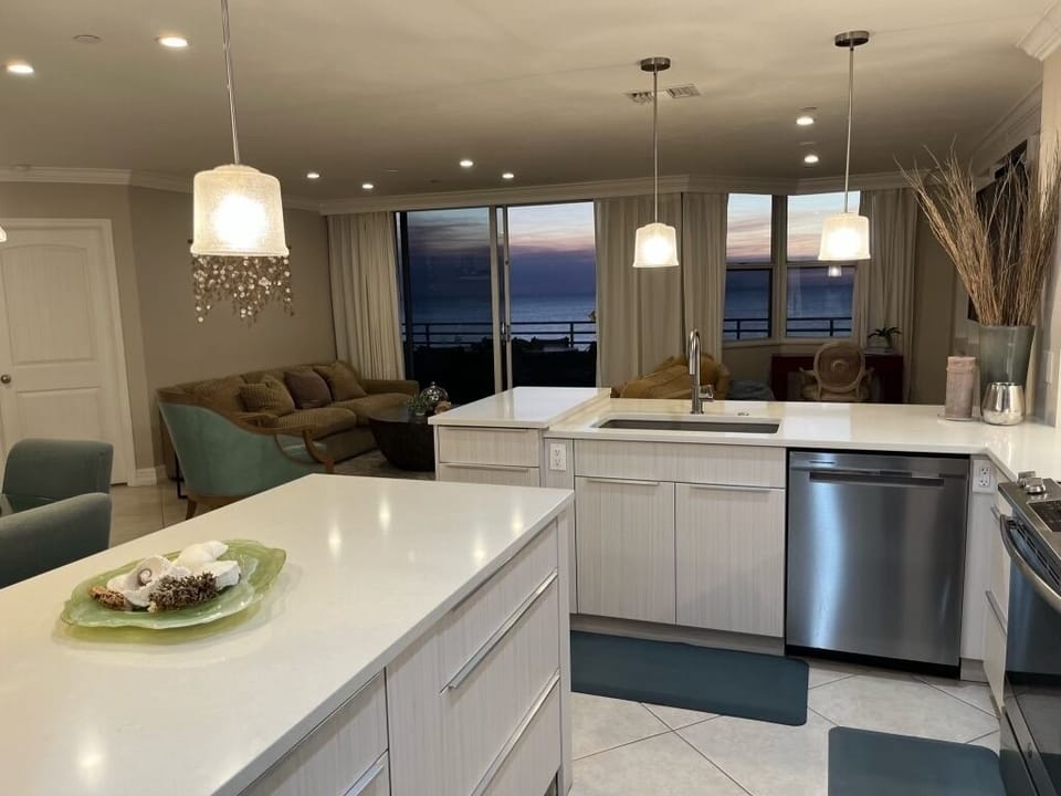 Kitchen has beautiful views of the water & a breakfast bar with 2 counter stools