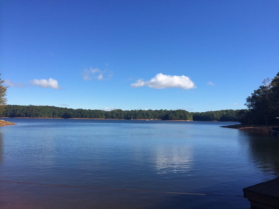 Summer views provide a green tree line with placid water