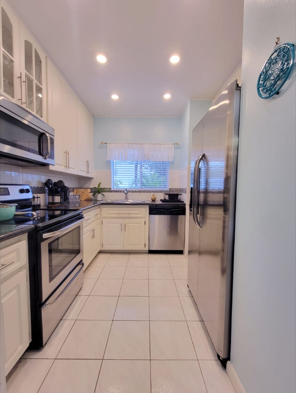 Fully equipped kitchen with stainless steel appliances.