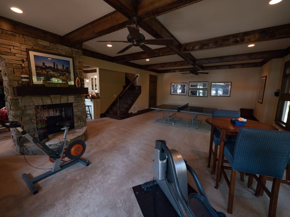 Game and exercise area features ping-pong, cards, stationery bike and elliptical