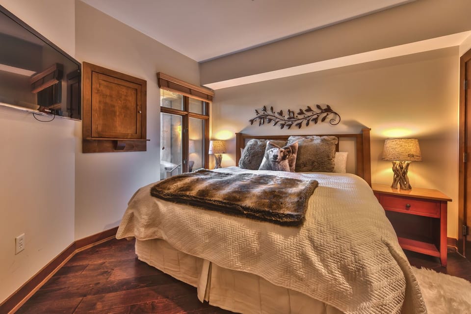 Bedroom features a king bed, European duvet, flat screen TV