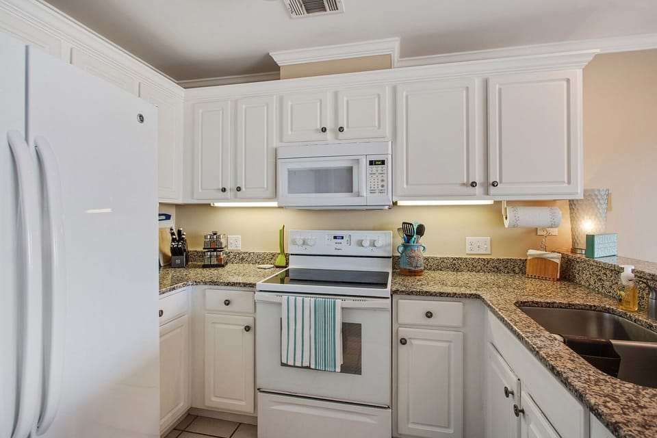 Fully equipped kitchen with dishes, utensils, pots & pans, dishwasher and spices