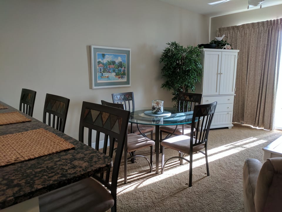 Entertainment center with flat screen TV, dining area.