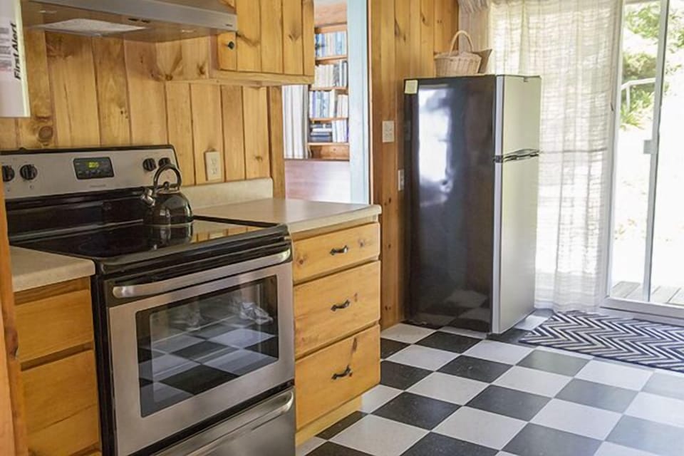 Kitchen range and refrigerator with walkthrough to living room