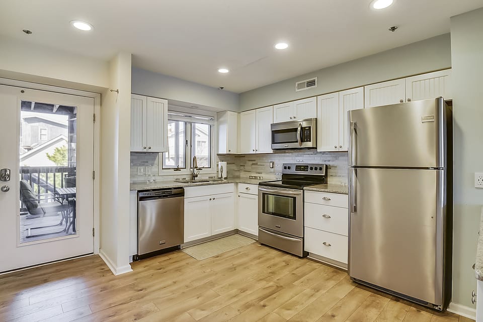 Remodeled, fully stocked kitchen with stainless steel appliances.