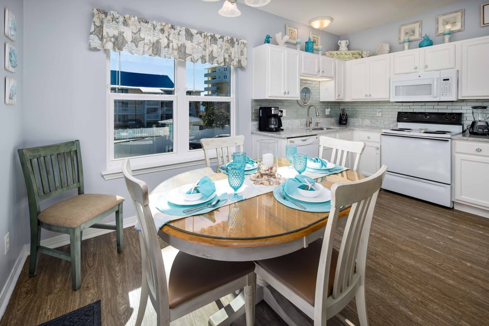 Large Dining &  Kitchen area has large window with partial views of the Gulf