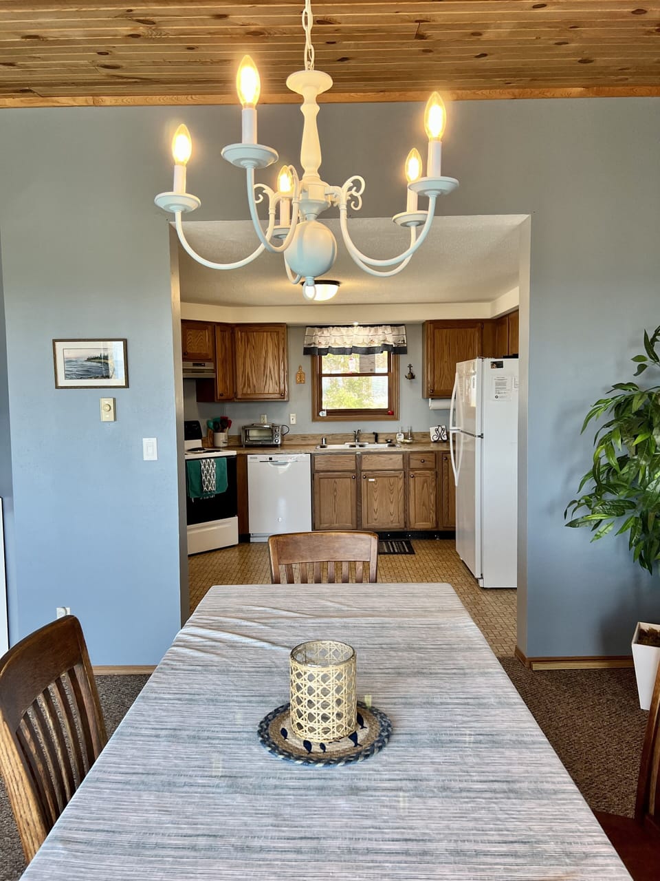 Kitchen open to eating area. New stove, dishwasher, and fridge.