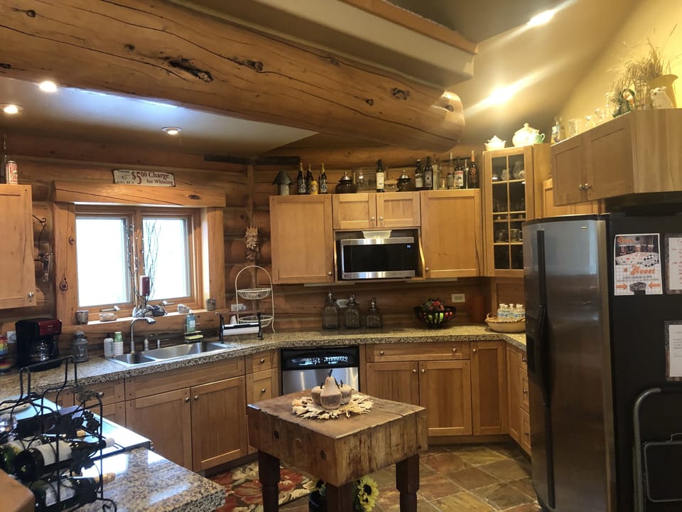 Fully stocked kitchen with antique butcher block island.