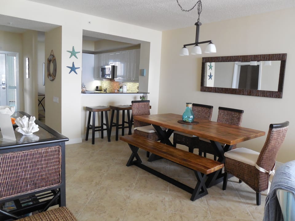 another view of dining room with three bar stools at counter