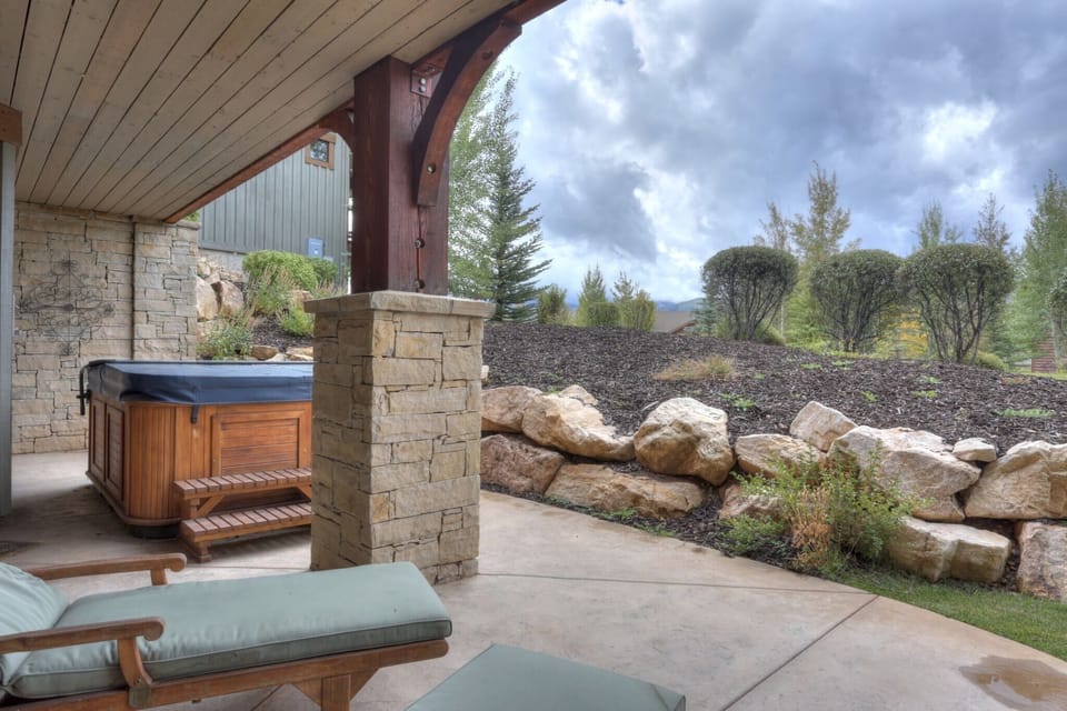 Private outdoor hot tub with lounge chairs
