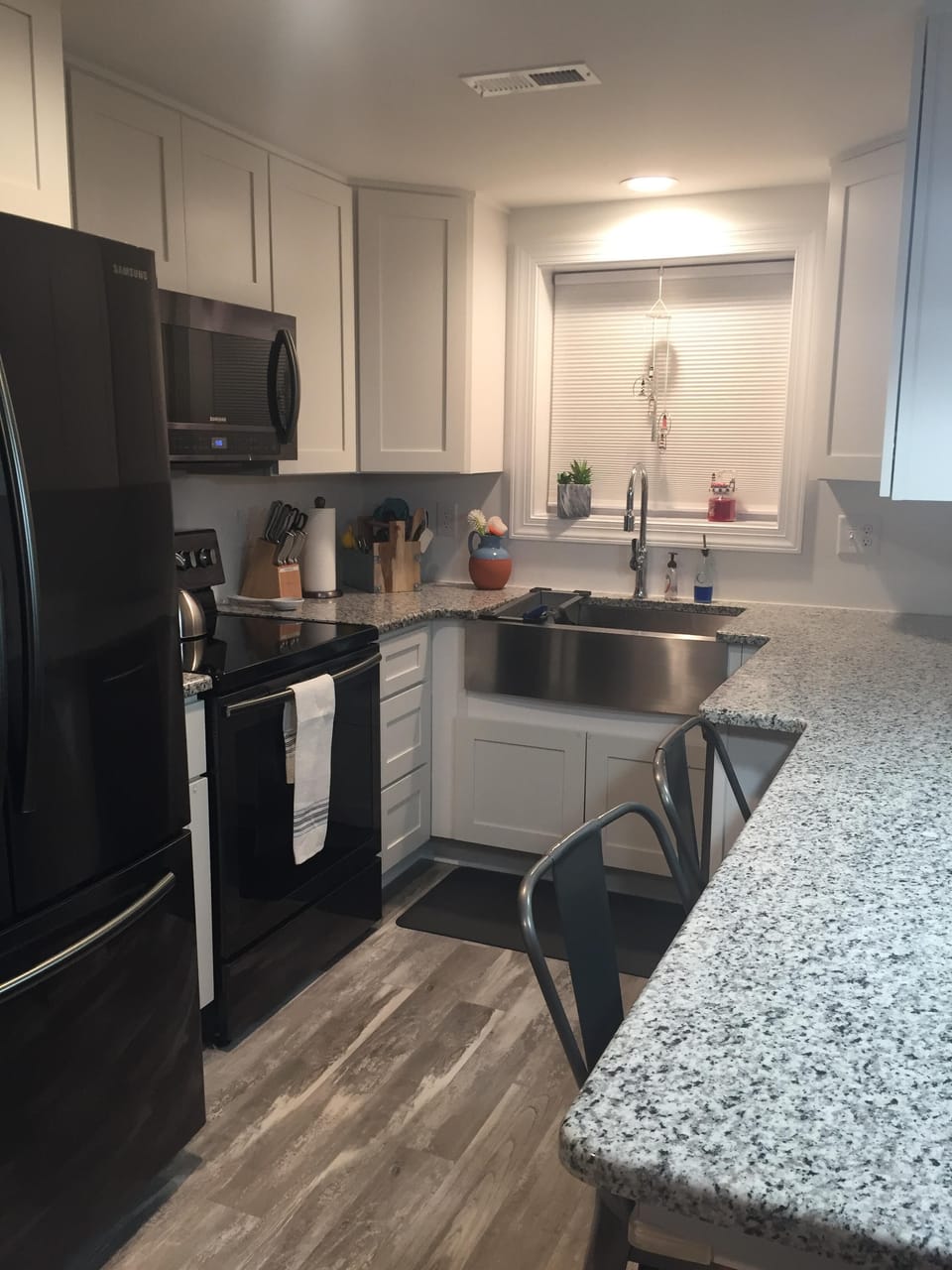 well equipped kitchen with granite.  counter tops extend to bar with seating.