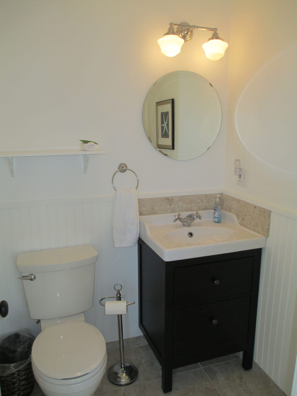 Powder room off kitchen, attached to bedroom.