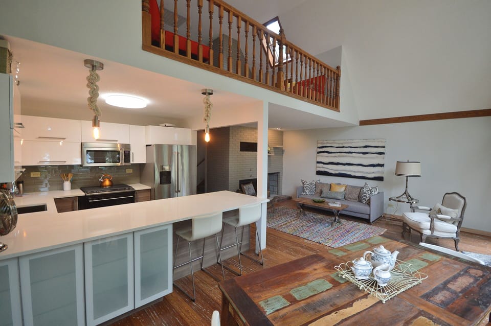 Open and spacious modern kitchen, dining area, and living area with huge windows