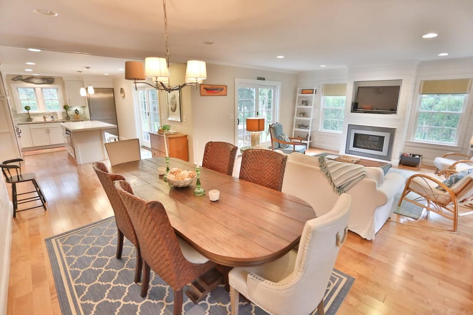 open living/dining (seats 10) and kitchen with french doors to deck