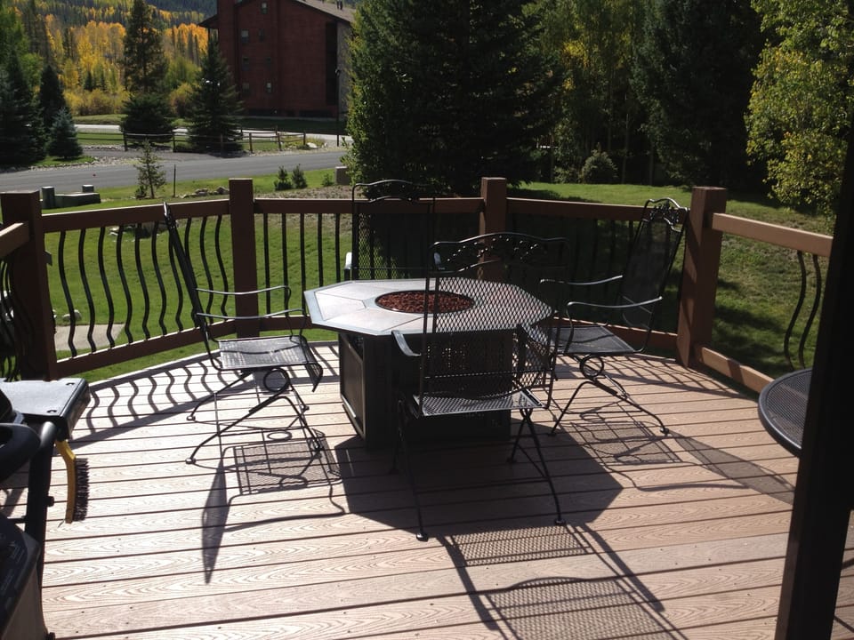 Expanded deck with firepit, table and chairs, bbq and views of Peak One.