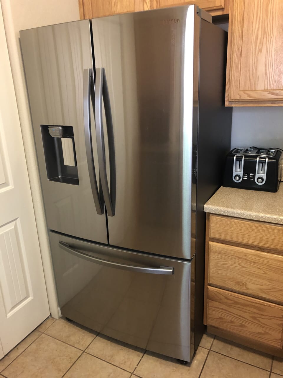 Fridge with water and ice in the door.  Another ice maker in the freezer