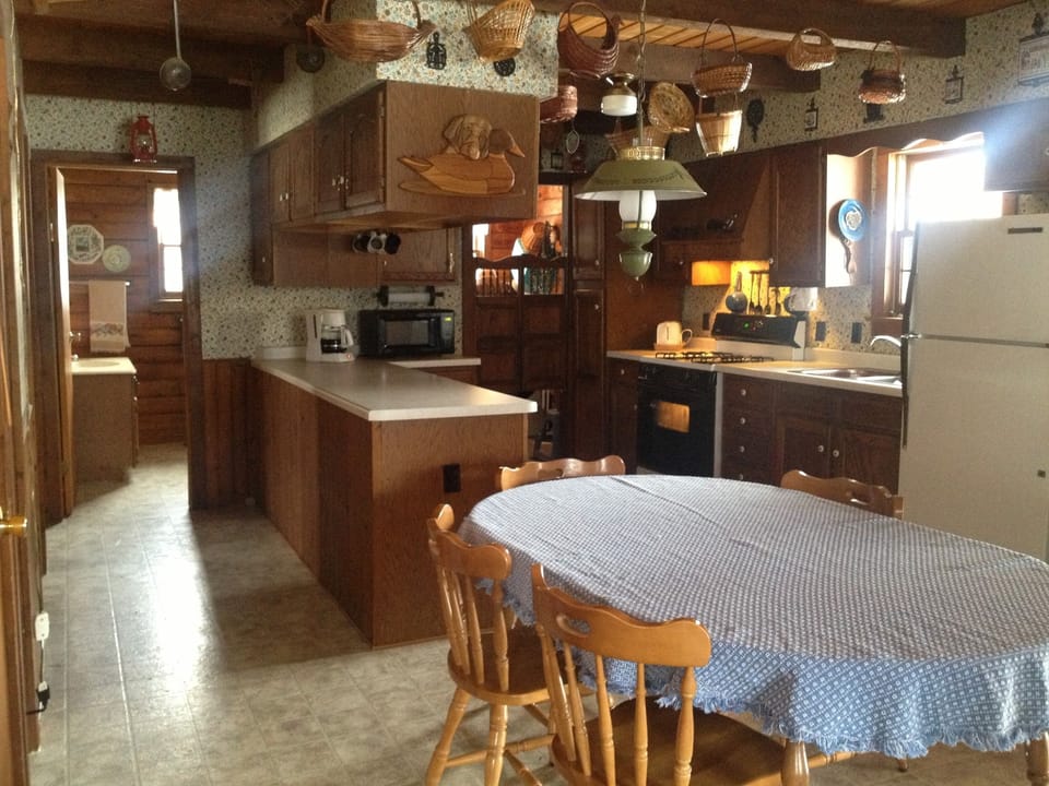 Dining area and kitchen, with bath in background