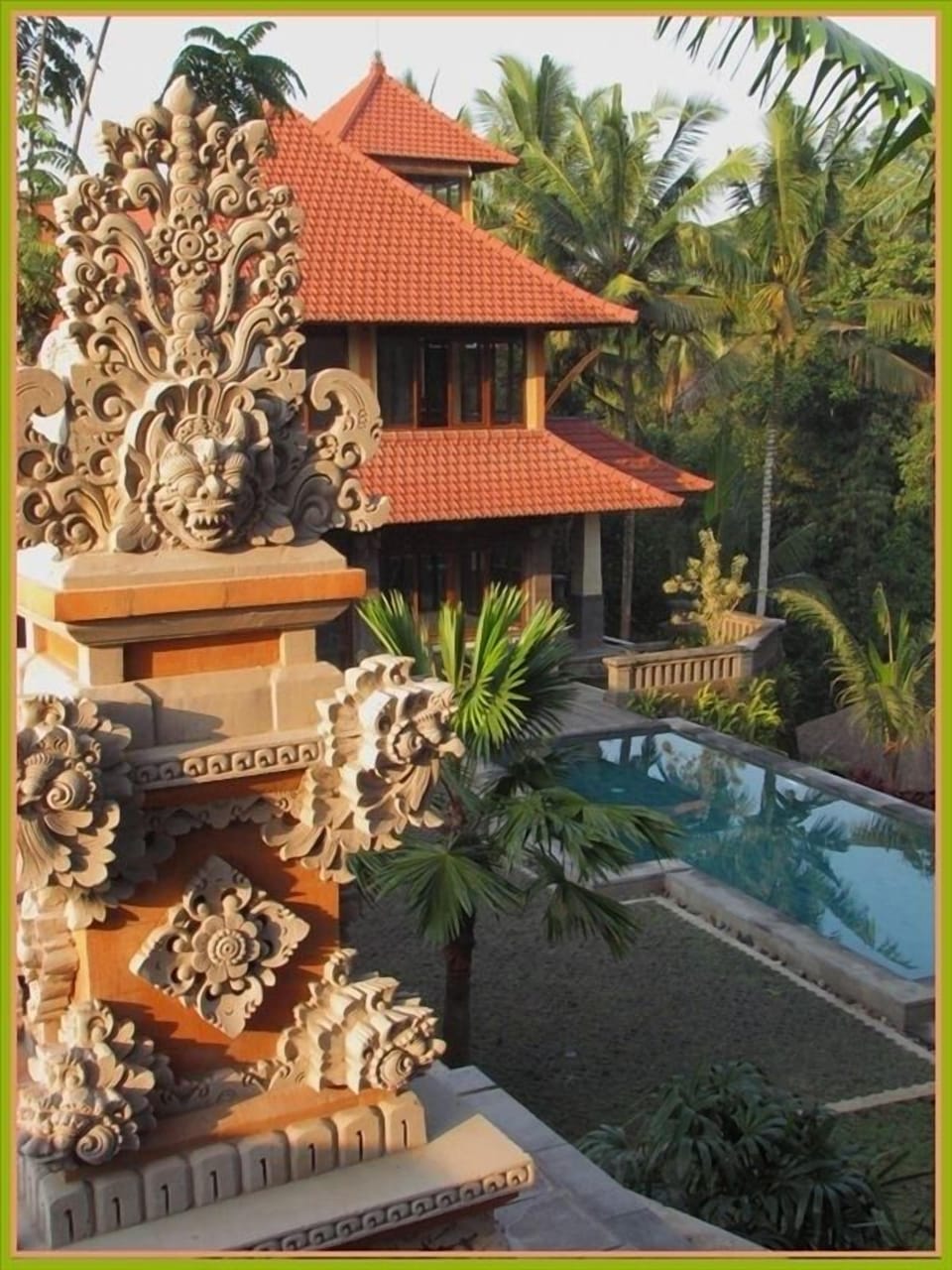The hand-carved Balinese temple with the house and pool in the background