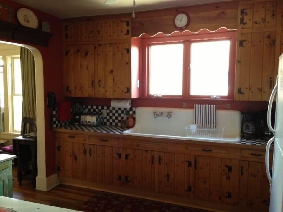 Kitchen with original cabinets and high back sink.