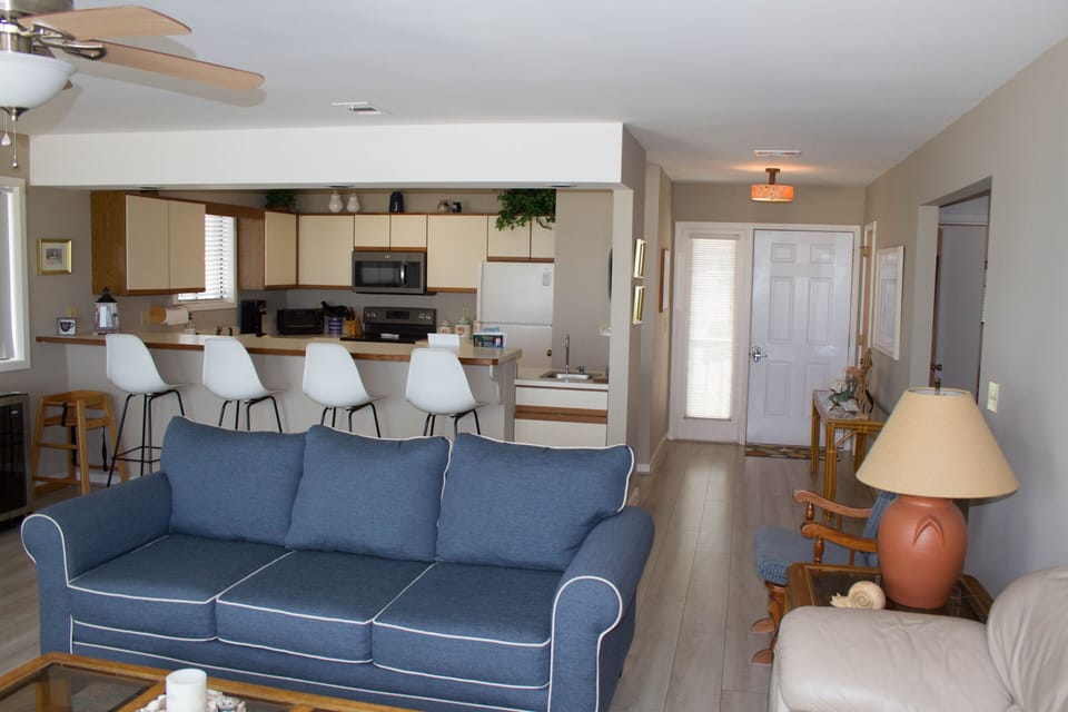 Open living and kitchen area with bar seating for 4