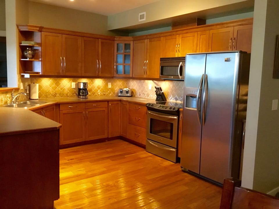 Modern kitchen with stainless steel appliances.