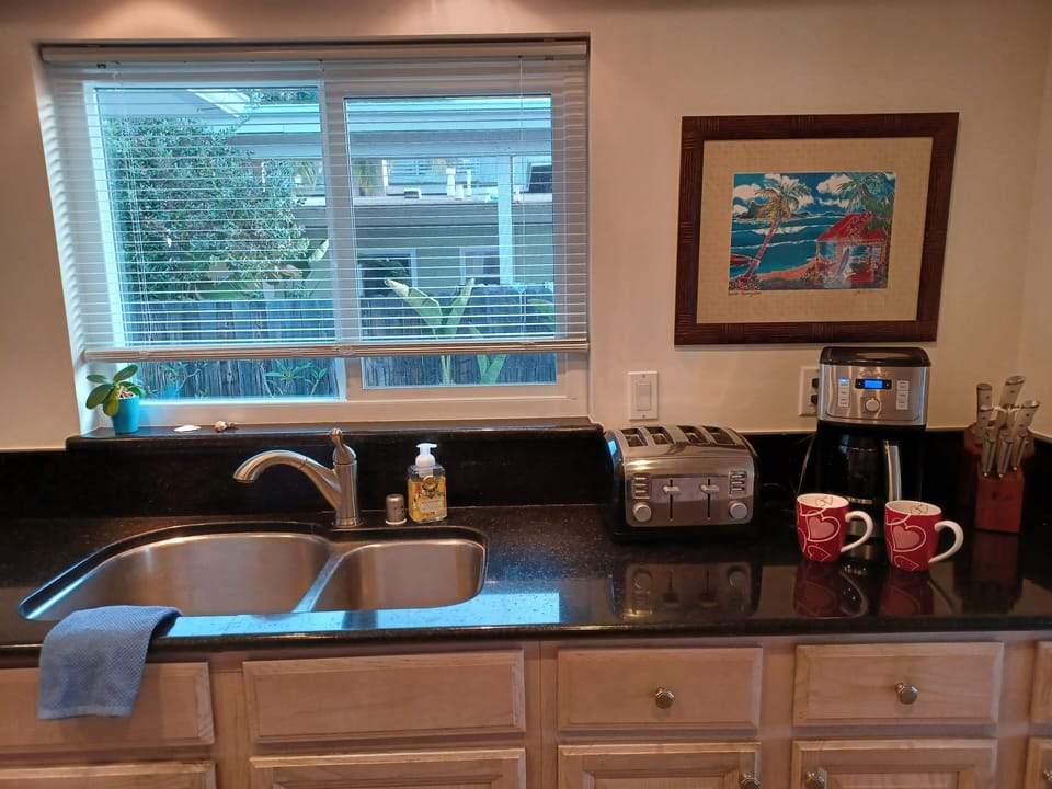 14 cup coffee pot with regular coffee provided and variety of creamers, and teas