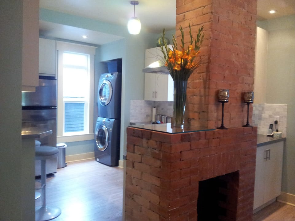 Bright kitchen with quiet steam  laundry, sit up breakfast bar & dishwasher