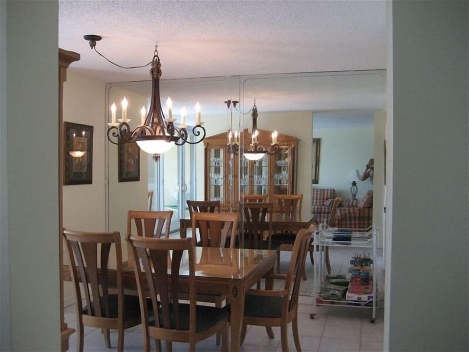 FORMAL DINING ROOM OVERLOOKING BALCONY, POOL AND OCEAN