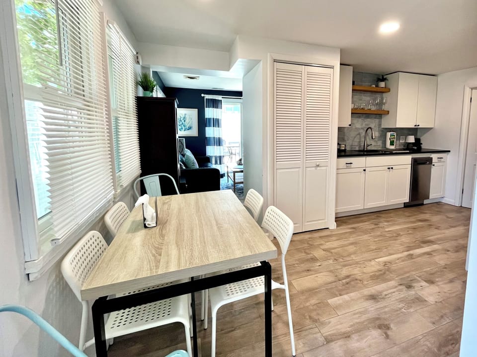 Dining table, seats 6. Stackable washer/dryer located behind louvered doors