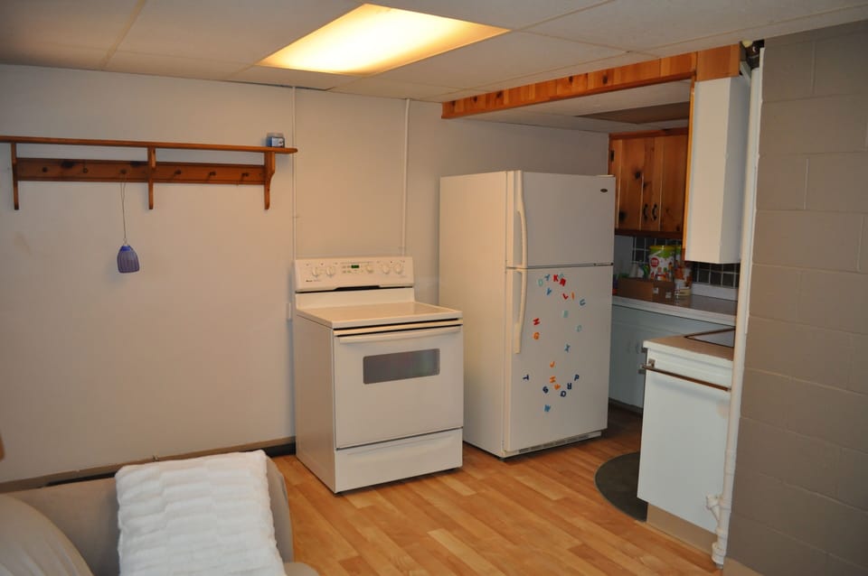 Extra refrigerator and full size oven in lower level kitchenette.
